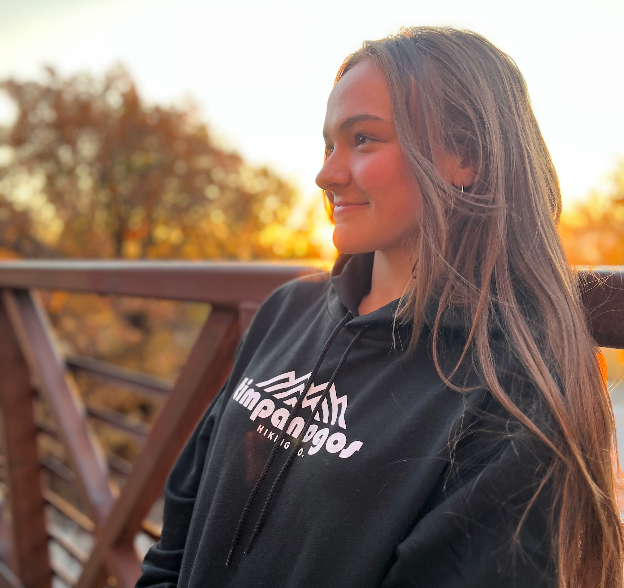 attractive young girl in blue goat shirt in the mountains